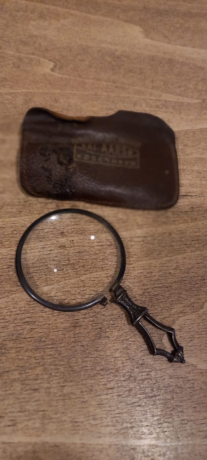 The main photo for An antique magnifying glass with leather case